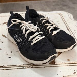 Skechers women’s Black and White Sneakers